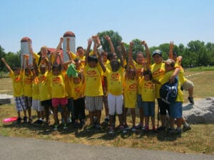 Youth with their hands raised cheering at Grist Mill Park