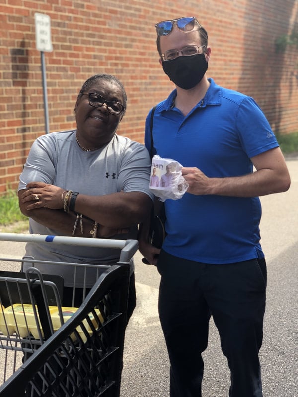 Woman giving homemade gif mug to staff member for appreciation