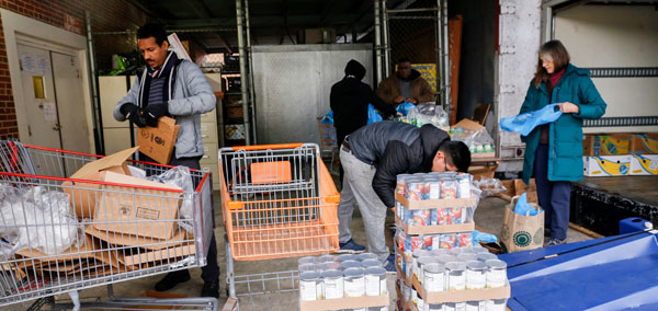 Volunteers and staff unpacking food from the United Community truck