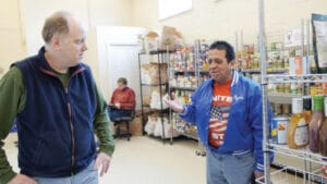 Staff and resident in the food pantry