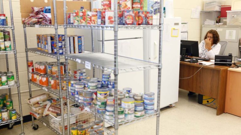 United Community food pantry with staff answering phone
