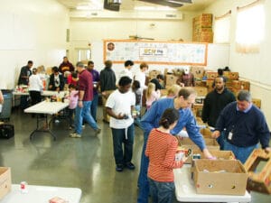 A group of volunteers and staff organizing food