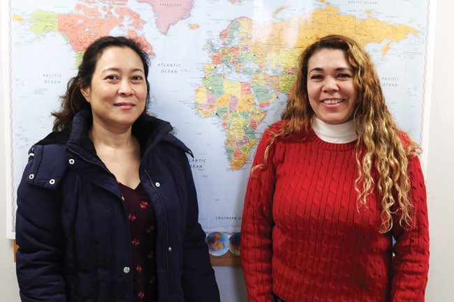 Two women standing in front of a map at Progreso