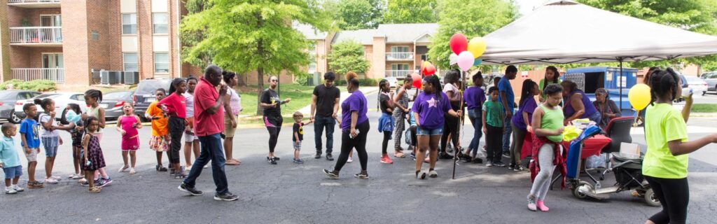 A large group lined up to enter the Creekside Village Community Center community day