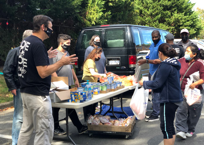 Volunteers handing out food bags to the community