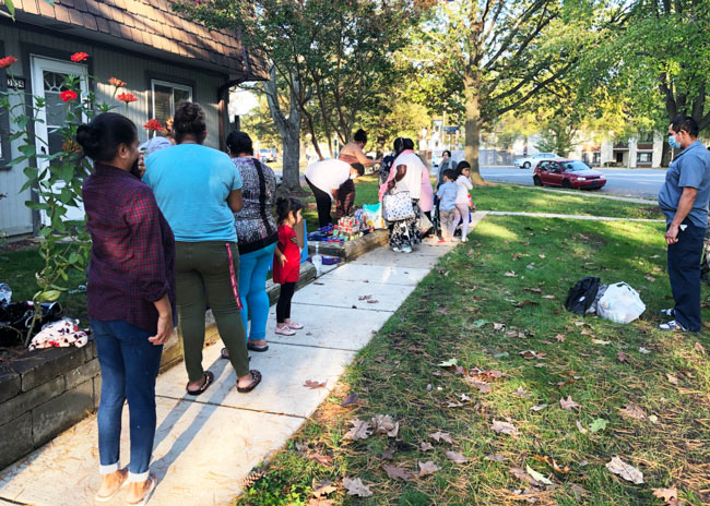 Local residents lined up in to receive food bags