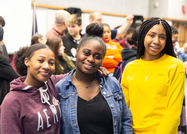 Middle schoolers smiling at a mentoring event