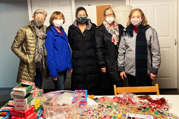 Members of the Friends of United Community volunteering to organize donated treats