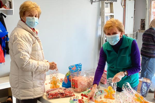 Two members of the Friends of United Community organizing donated treats