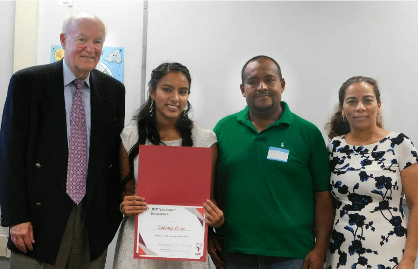 Zulemy and her parents with Mr. Valencourt when Zulemy recieved the Valencourt Scholarship at Progreso Center