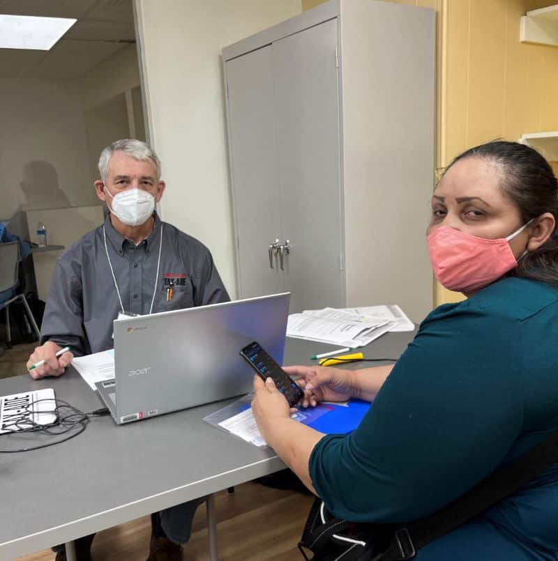 A tax assister and client working to finish her taxes