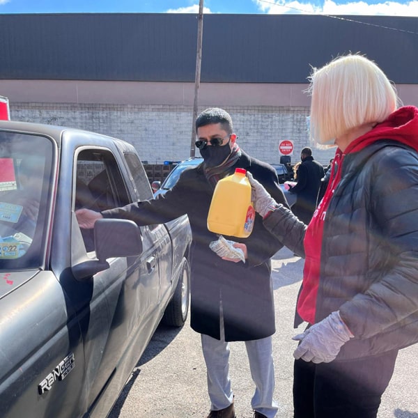 CEO Alison DeCoursey and De Lune's President, Gaddafi Ismail, handed out fresh eggs and milk