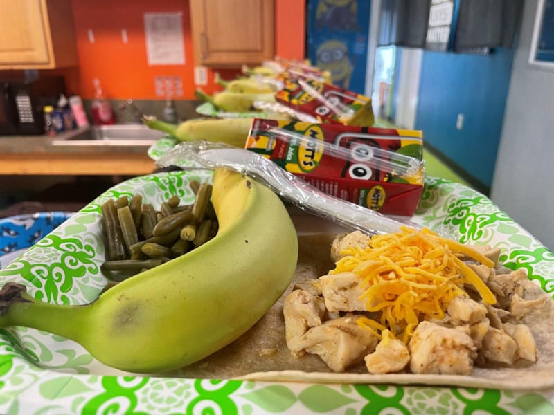 One of the hot meals served to the youth at Creekside and Sacramento Community Centers. There's a banana, green beans, chicken with cheese on it, and a juice box.