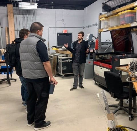 Two men listen to another instructor as they start their new job with Building Momentum