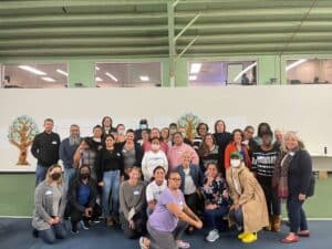 photo of people gathered together for a group photo, all smiling at the camera